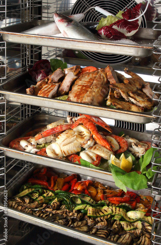Interior of a blast chiller with fish and vegetables 