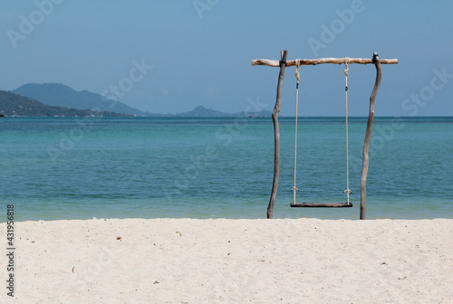 The wooden swing on the beach. © noomcm