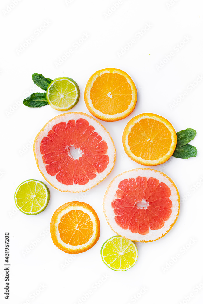 Citrus fruits on a white background are cut . Colored fruits. The citrus family. citrus sliced layout top view on a white background. An article about healthy eating. Keto diet. Citrus fruits on a white background are cut . Colored fruits. The citrus family. citrus sliced layout top view on a white background. An article about healthy eating. Keto diet.