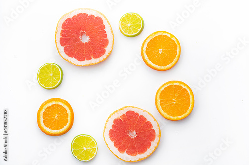 Citrus fruits on a white background are cut . Colored fruits. The citrus family. citrus sliced layout top view on a white background. An article about healthy eating. Keto diet.