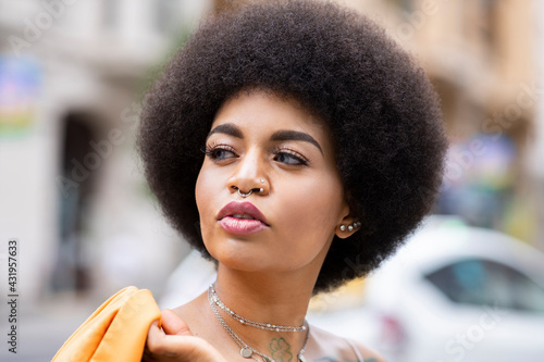 Afro woman contemplating outdoors photo