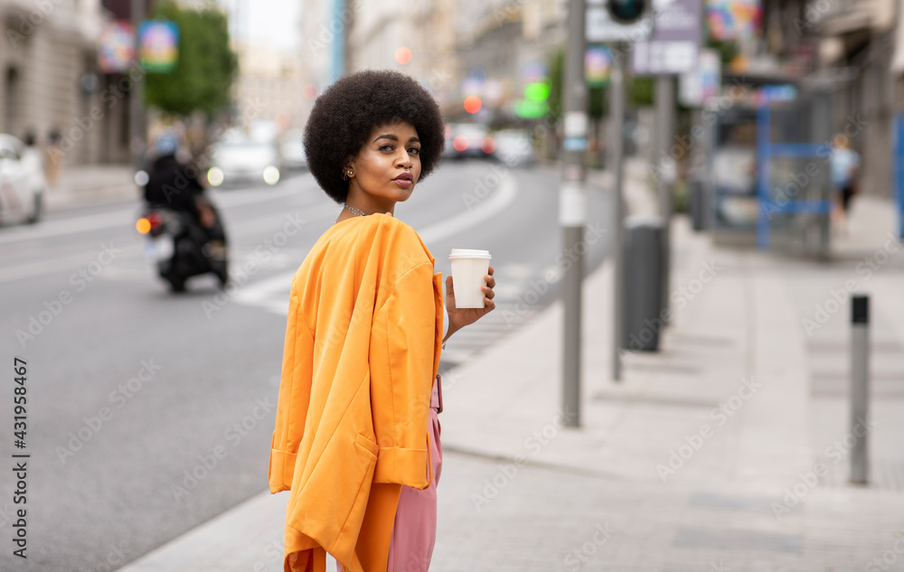 Female hipster with coffee cup on footpath Female hipster with coffee cup on footpath