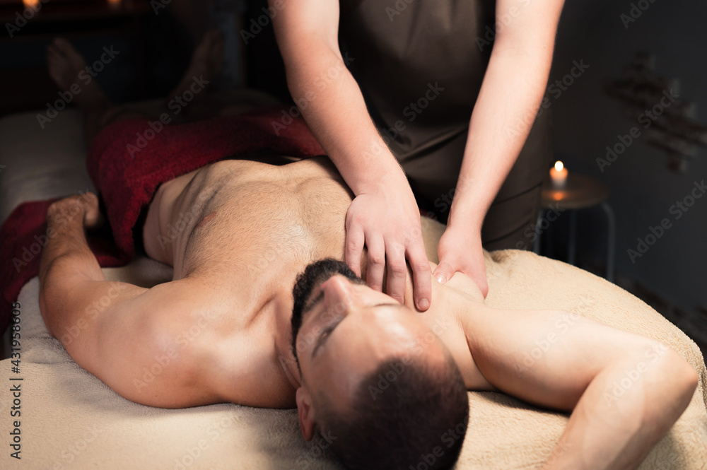 Fototapeta premium Sports massage. Breast massage. Physiotherapist doing a male breast massage to an athlete to a patient.