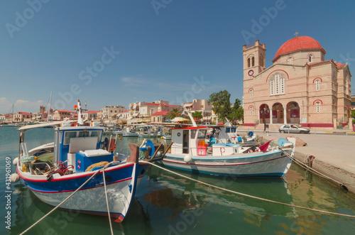 Port of charming Aegina town with yachts and fishermen boats docked in Aegina island  Saronic gulf  Greece  in a sunny summer morning