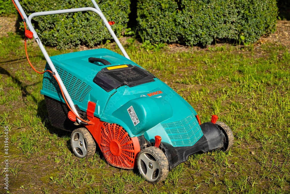 Scarifier, verticutter, aerator BOSH AVR 110 is on lawn. Electric Scarifier Bosch  AVR 110 with grass catcher. Create perfect lawn. Scarifier is like lawn  mower. Krasnodar, Russia - April 27, 2021 Stock Photo | Adobe Stock