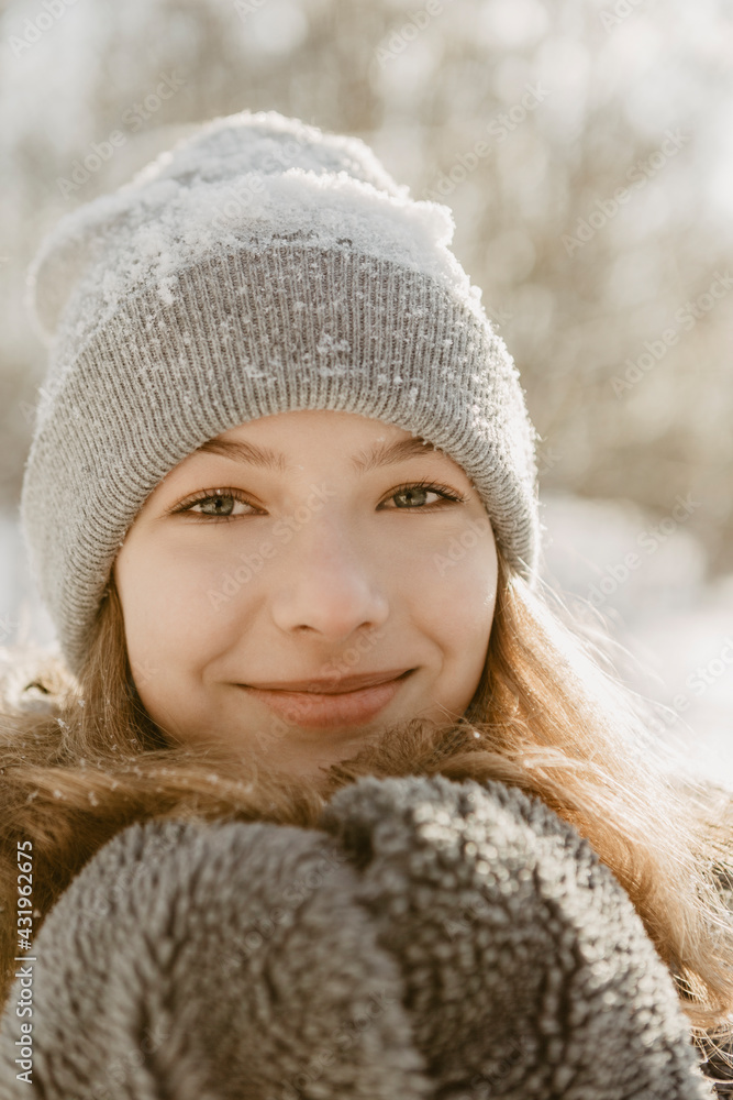 Portrait of beautiful teenage girl wearing knit hat smiling at camera Portrait of beautiful teenage girl wearing knit hat smiling at camera