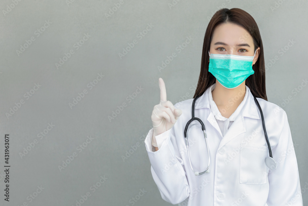 Woman doctor wearing medical face mask showing sign Woman doctor wearing medical face mask showing sign