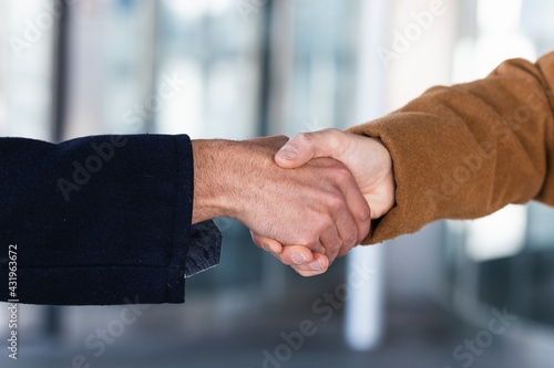 Business partners shaking hands outdoors photo