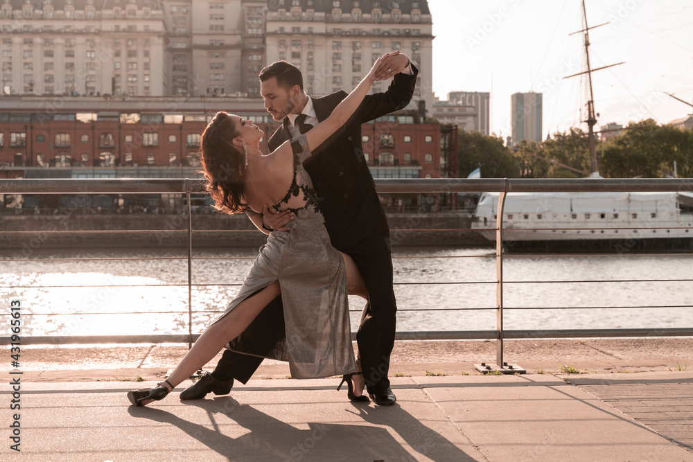 © Spectral/Westend61 - Male and female Tango dancers practicing on pier during summer