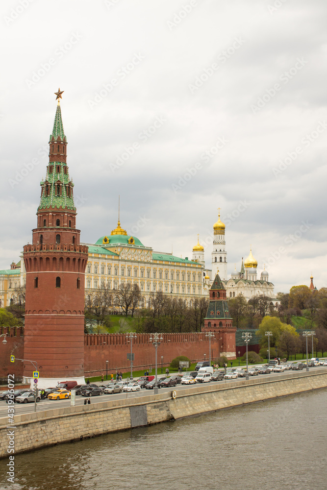 panoramic view of the Moskva River and the Kremlin embankment with a red brick wall, water tower, the Grand Kremlin Palace and the bell tower of Ivan the Great against the in Moscow Russia