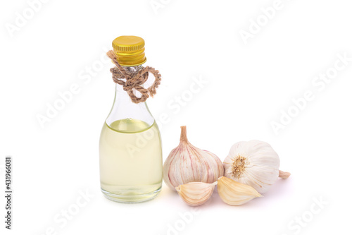 Garlic essential oil in clear bottles and garlic isolated on white background Herbs to prevent COVID-19