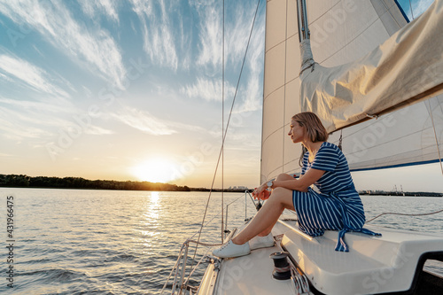 Luxury travel on the yacht. Young happy woman on boat deck sailing the river. © luengo_ua