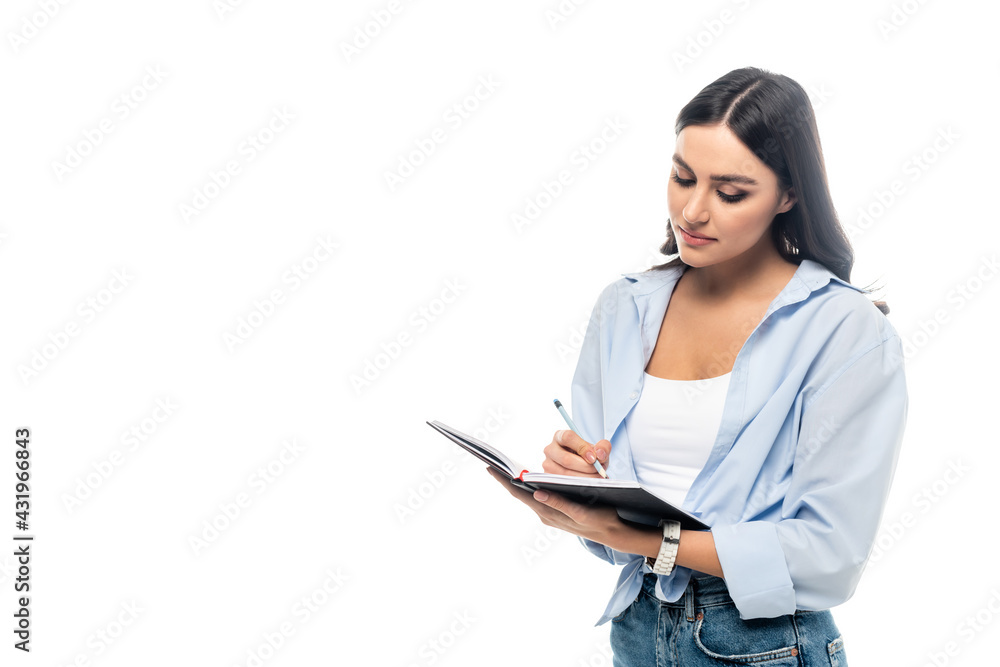 young businesswoman in casual clothes writing in notebook isolated on white. young businesswoman in casual clothes writing in notebook isolated on white.
