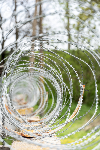 round barbed wire. the territory around the perimeter is fenced with wire.
