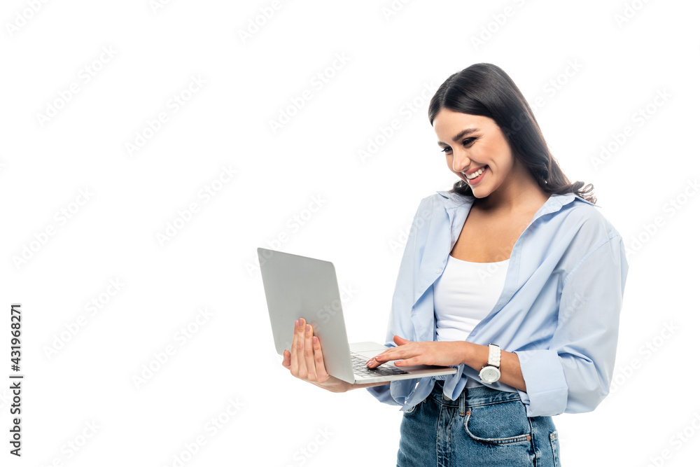 cheerful businesswoman in blue shirt typing on laptop isolated on white. cheerful businesswoman in blue shirt typing on laptop isolated on white.