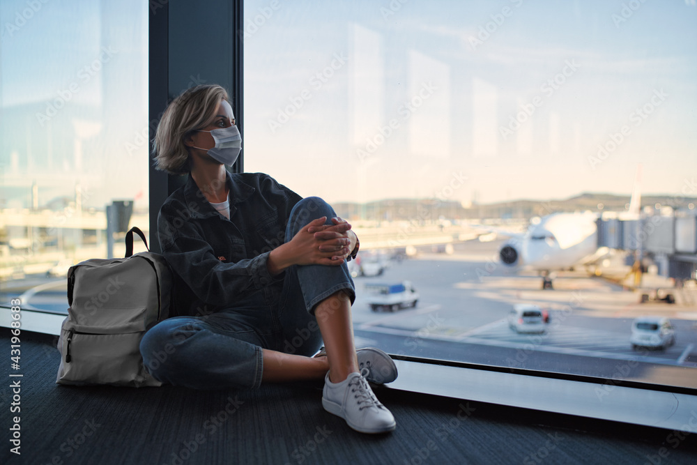 New normal and social distance concept. Young woman tourist wearing face mask during corona virus outbreak at airport. New normal and social distance concept. Young woman tourist wearing face mask during corona virus outbreak at airport.