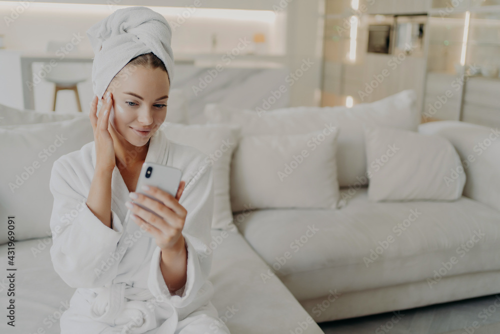Woman beauty blogger creating video on smartphone for her vlog about daily skincare routine Woman beauty blogger creating video on smartphone for her vlog about daily skincare routine
