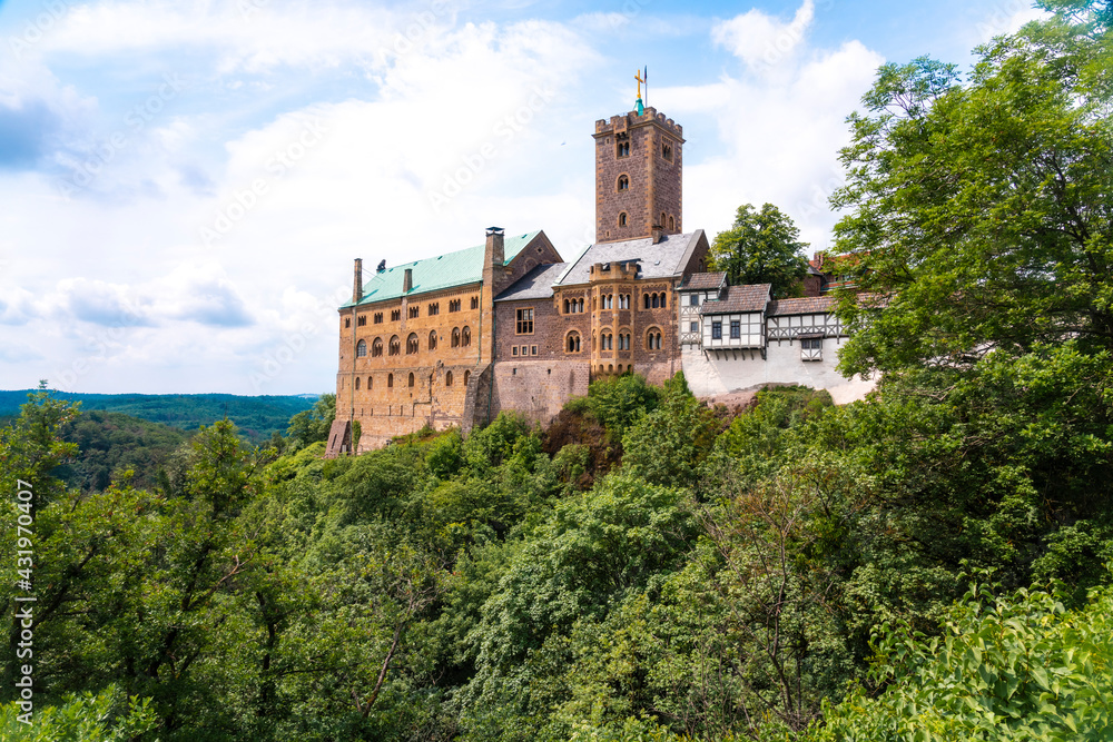 Wartburg Castle by Thuringer forest against cloudy sky at Eisenach, Germany Wartburg Castle by Thuringer forest against cloudy sky at Eisenach, Germany