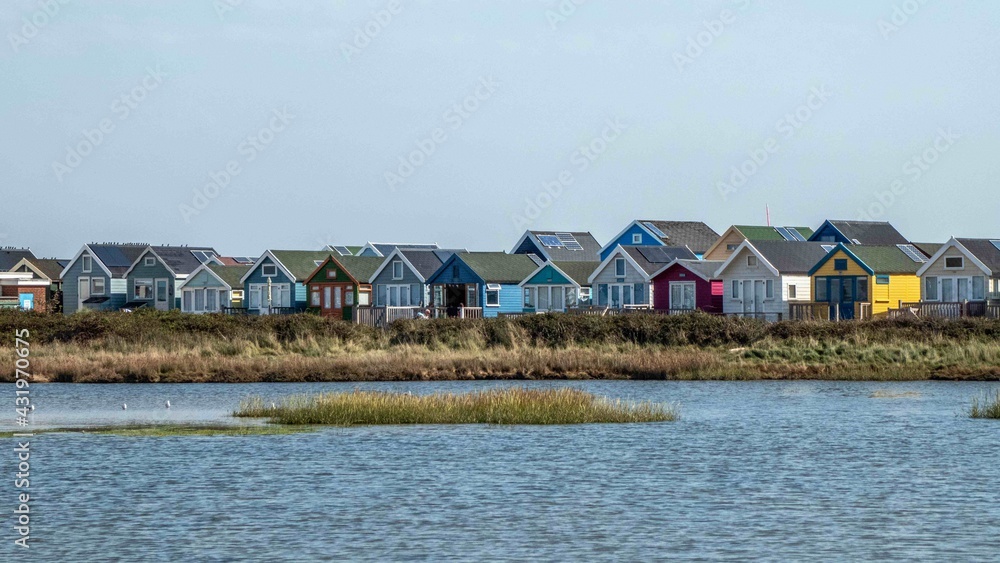 bright colourful beach huts by the sea