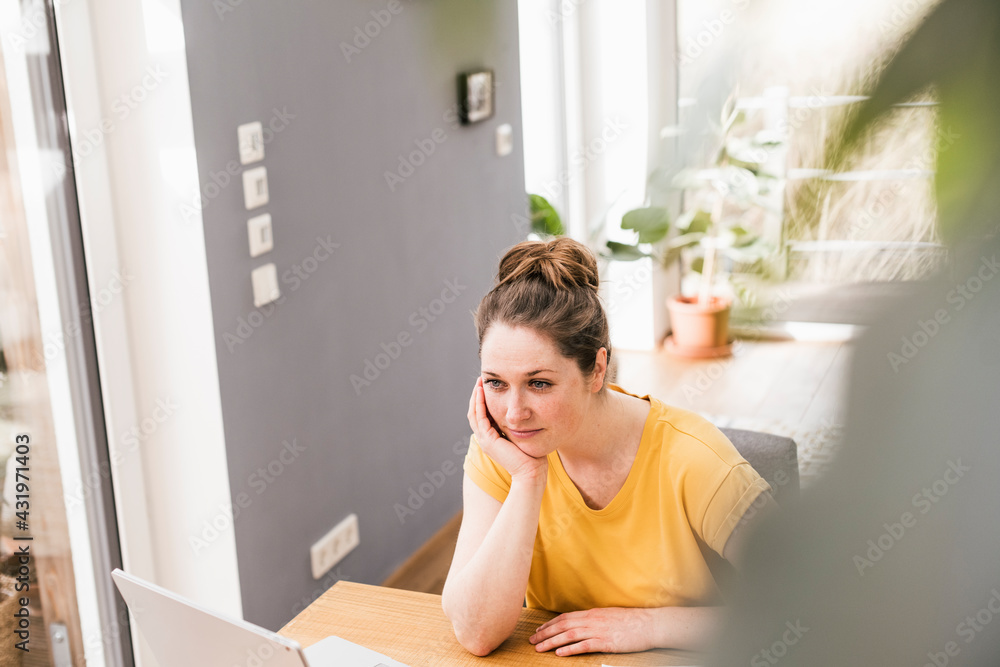 Thoughtful businesswoman sitting at desk Thoughtful businesswoman sitting at desk