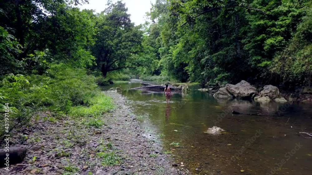 Young Woman in Bikini Walking in the River, Thailand. Drone. Young Woman in Bikini Walking in the River, Thailand. Drone.