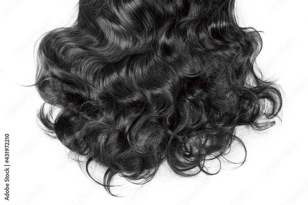 Black hair texture. Wavy long curly dark hair close up isolated on white. Hair extensions, materials and cosmetics, hair care, wig. Hairstyle, haircut or dying in salon