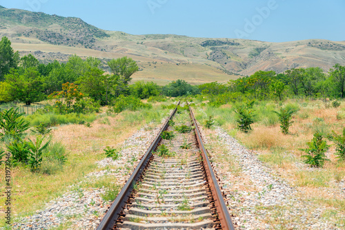 Rails and view of hills on a sunny summer day landscape