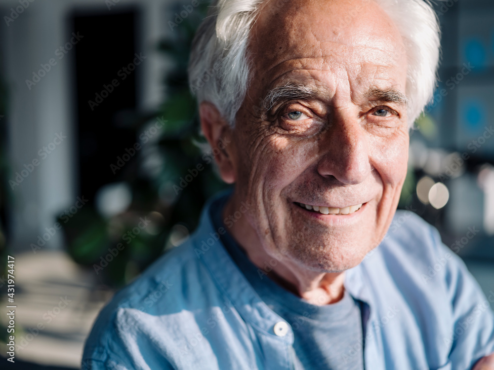 Smiling businessman staring while standing at office Smiling businessman staring while standing at office