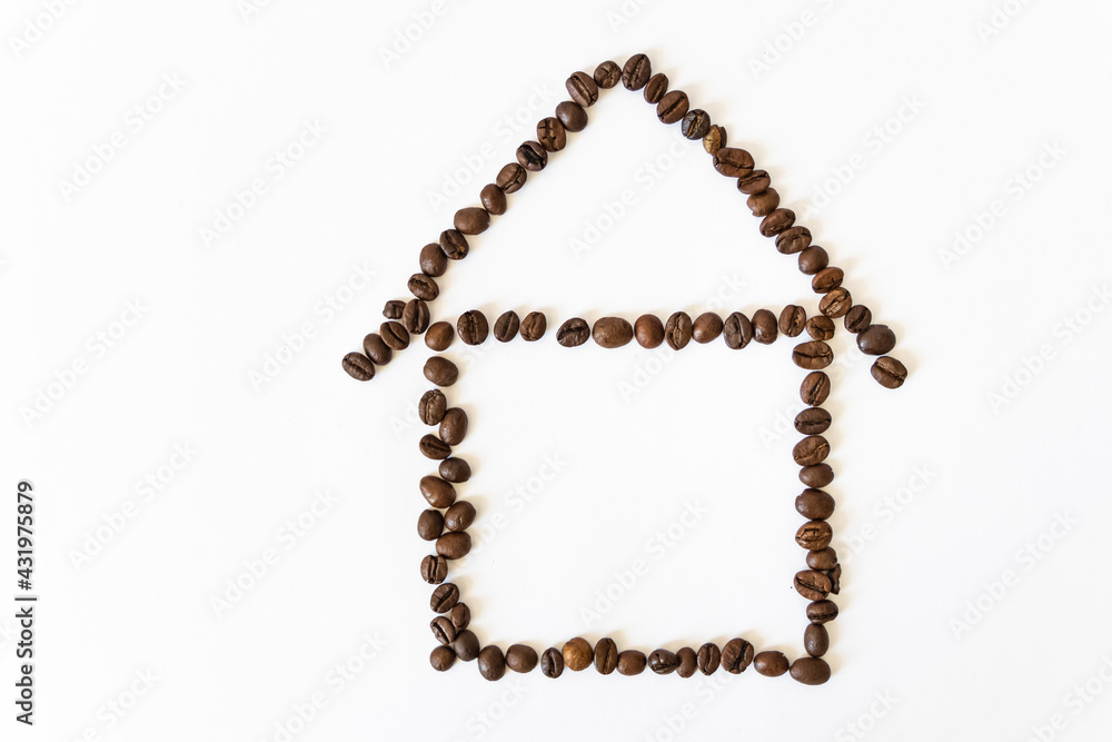 coffee beans on a white background in the shape of a house. homemade coffee. coffee beans on a white background in the shape of a house. homemade coffee.