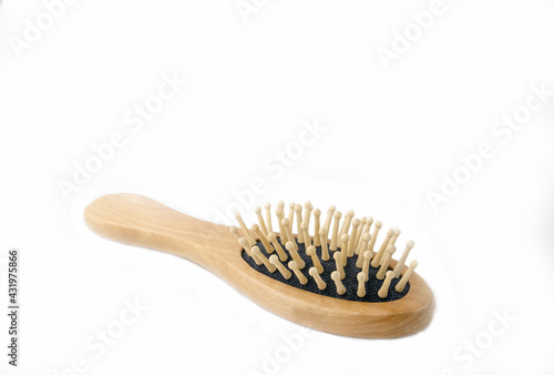 Wooden massage comb on a white background.
