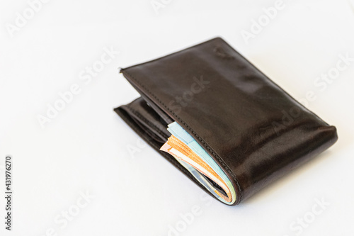 Wallpaper Mural black wallet full of money on a white background. Torontodigital.ca