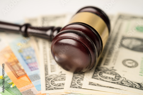 Gavel for judge lawyer and US dollar with EURO banknotes, finance concept.