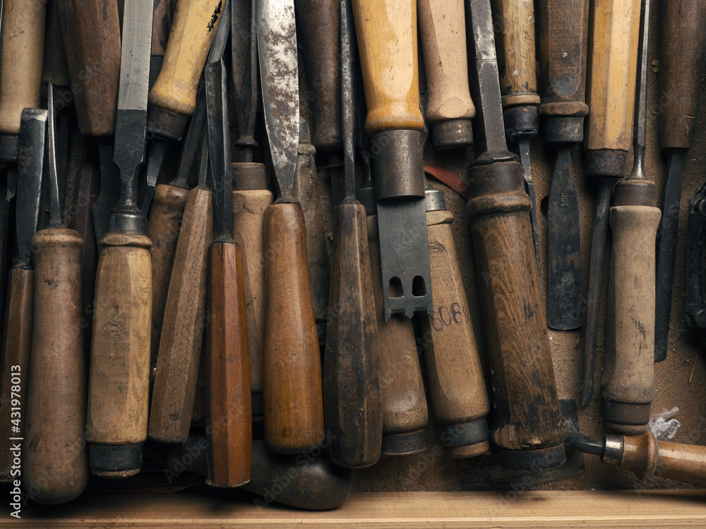 Old used chisel in a workbench drawer, craft or manufacturing concept Old used chisel in a workbench drawer, craft or manufacturing concept
