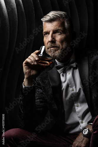 Portrait of a gentleman holding a glass of alcohol photo