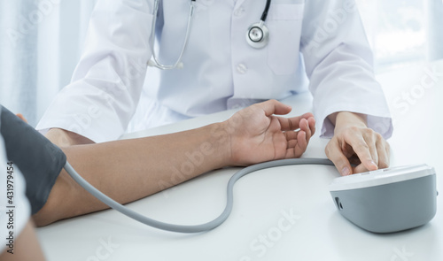 The doctor woman hand use the pulse meter to measure the pressure of the patient, medical checkup concept