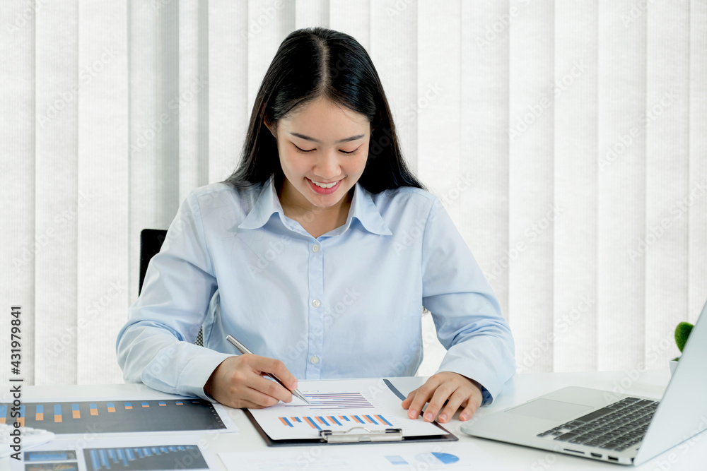 Businesswoman analysis the chart and meeting Video Conferencing with laptop at the home office for setting challenging business goals And planning to achieve the new target Businesswoman analysis the chart and meeting Video Conferencing with laptop at the home office for setting challenging business goals And planning to achieve the new target