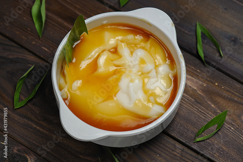 Bubur Sumsum or Javanese dessert porridge of rice flour, coconut milk with palm sugar  photo