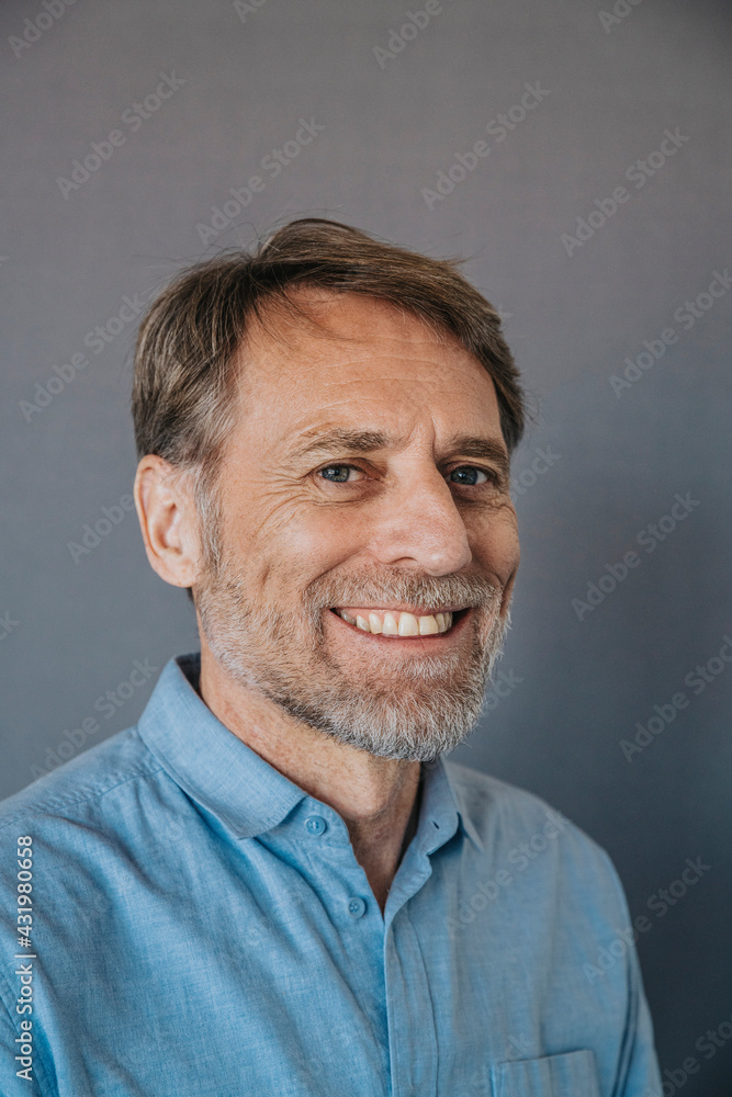 Smiling man with gray eyes on gray background Smiling man with gray eyes on gray background