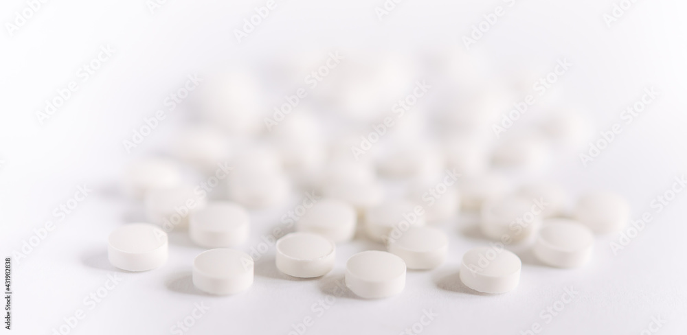 White pills on a white background. round pills close-up. Healthcare and medicine.