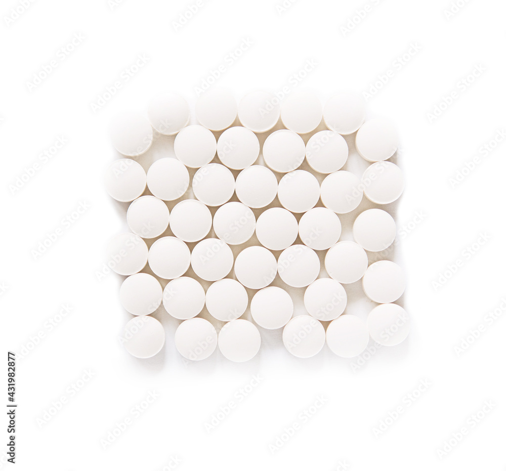 White pills on a white background. round pills close-up. Healthcare and medicine. White pills on a white background. round pills close-up. Healthcare and medicine.