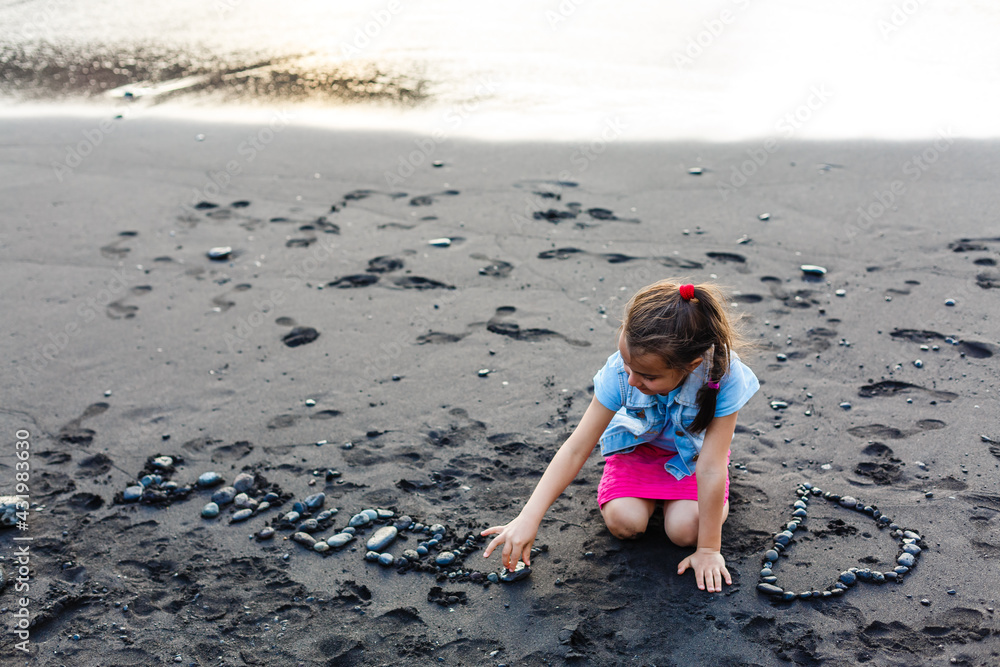 Adorable happy brunette young girl on beach vacation in the stormy day Adorable happy brunette young girl on beach vacation in the stormy day