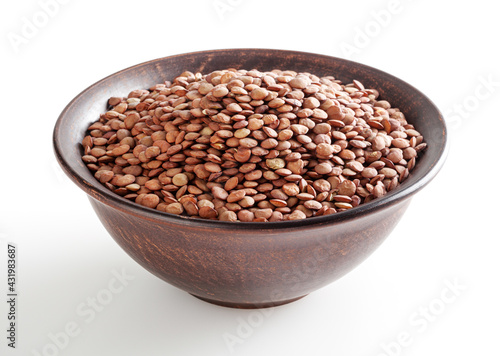 Uncooked lentils in ceramic bowl isolated on white background