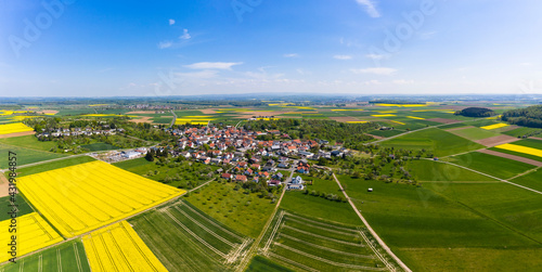 Germany, Hesse, Munzenberg, Helicopter panorama of countryside village and surrounding fields in summer photo