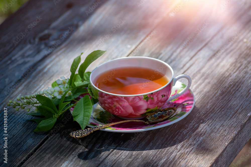 Morning cup of tea on the background of the spring garden.