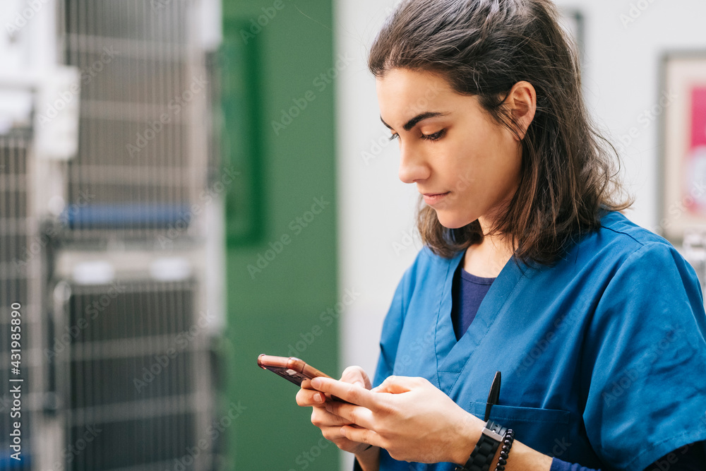 Female nurse using mobile phone in hospital Female nurse using mobile phone in hospital