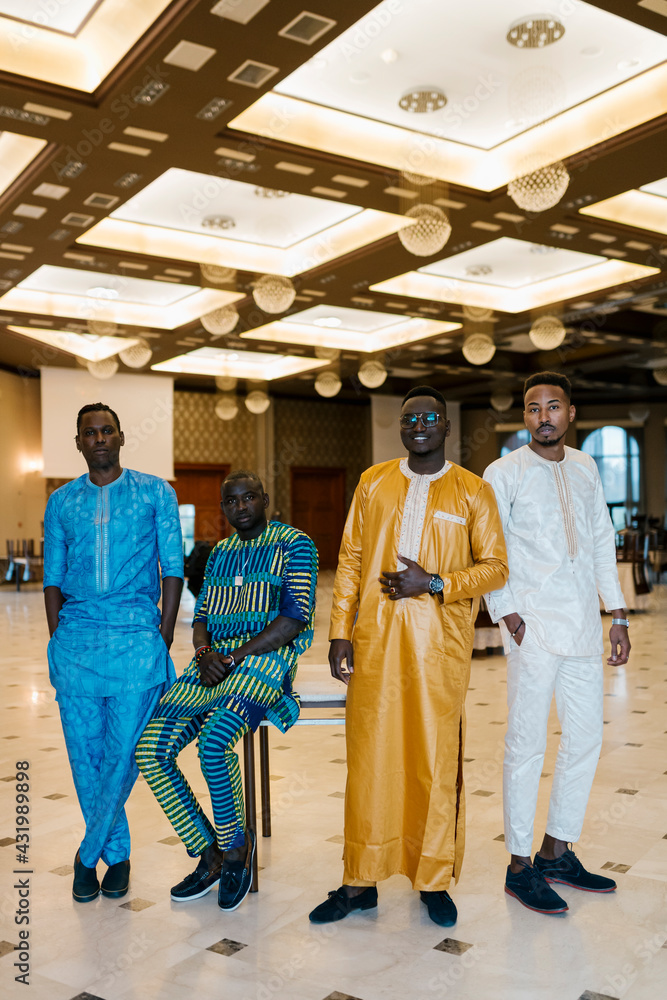 Groom standing with friends in wedding at banquet Groom standing with friends in wedding at banquet