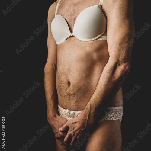 Young homosexual man posing in women's bra and panties