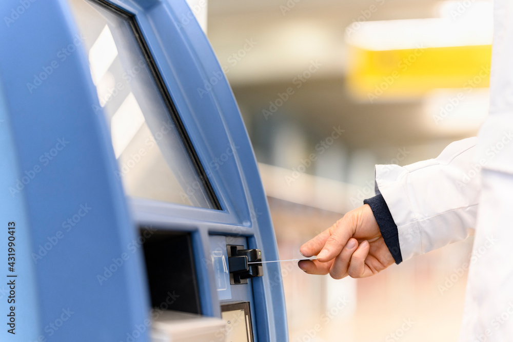 Man's hand withdrawing money at ATM machine Man's hand withdrawing money at ATM machine
