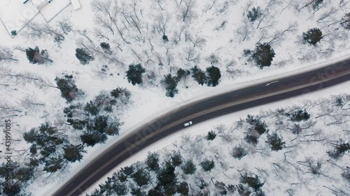 Riding a car on a winter road The drone view of winter driving Forest 
Winter Russia Siberia Krasnoyarskiy Kray Krasnoyarsk photo