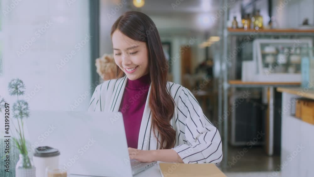 young attractive asian female wear casual cloth hand use smartphone and laptop device comminication social contact in cafe restaruant sit at counter next to big window daylight